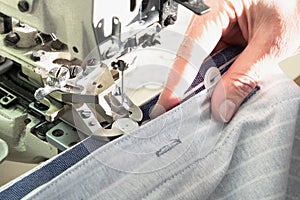 Textile industry, clothing production. Close-up of sewing equipment. Loops and buttons