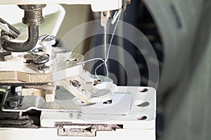 Textile industry, clothing production. Close-up of sewing equipment. Loops and buttons