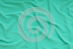 Textile light green background,  cloth as creative backdrop