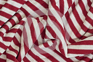 Textile texture, abstract background. Red - white striped color, smooth wavy lines