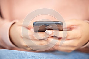 Texting, closeup and hands holding phone while typing an email or memo. Communication, social media and connectivity in