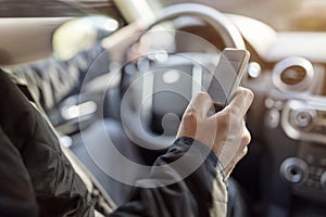 Texting while driving using cell phone in car photo