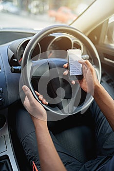 Texting and drivingan accident waiting to happen. a man using his phone while driving.