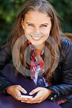 Texting a friend. Portrait of a beautiful teen sending a text message.