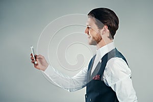 Texts are an easy way to stay in touch. Studio shot of a handsome young businessman sending a text message against a