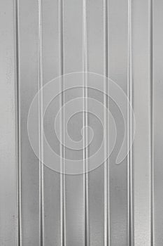Textural background of gray corrugated metal sheet or profiled panel.