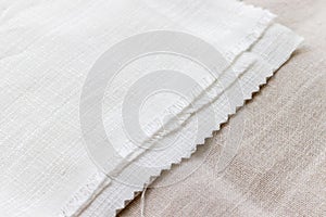 Textural background of two types of natural linen fabric lying on top of each other