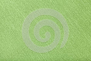 Textural of green background of wavy corrugated paper, closeup