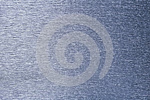 Textural of silver background of wavy corrugated paper, closeup