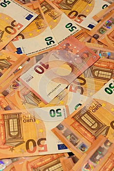 Texture of 50 euros, many identical bills that lie together.