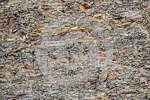 Texture. Abstract background. Layers and cracks in sedimentary rocks on the rock.