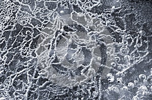 Texture abstract closeup background ice with grooves, furrows, and bubbles of air cought by frost in the mass of wated