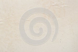 Texture of aged paper sheet, dirt stains, spots, wrinkle, creame beige color, vintage background