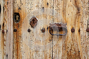 Texture of ancient wooden door with keyholes and handle