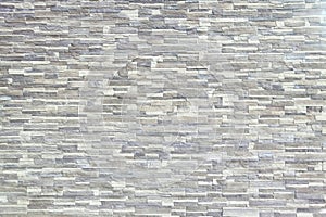 Texture - artificial decorative stone faÃÂ§ade. Decorative grey color rough stone wall background texture.