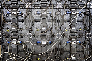 Texture of back view panels. Power input and output wire and data input and output plug. Digital electronic screen. Backside of