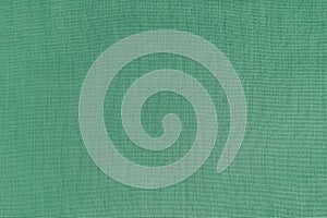 Texture background of green linen fabric, cloth surface, weaving of natural cotton fabric