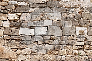 Texture of grey eroded stone on wall