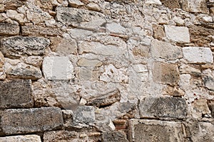 Texture of grey eroded stone on wall