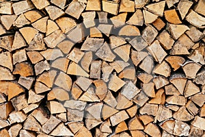 Texture background image of chopped firewood stacked in a woodpile, copy space