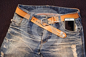 Texture background of jeans , belt detail with mobilephone and e