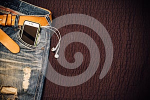 Texture background of jeans , belt detail with mobilephone and e
