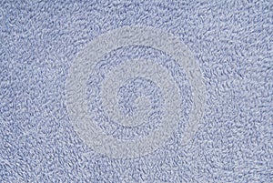 Texture background is out of light blue terry fabric, fluffy terrycloth, close-up of textile material, furry  textile, fuzzy,