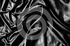 Texture, background, pattern. Black silk fabric. Fabric silk elastane satin black flowing stretch noble