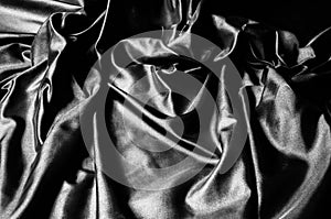 Texture, background, pattern. Black silk fabric. Fabric silk elastane satin black flowing stretch noble