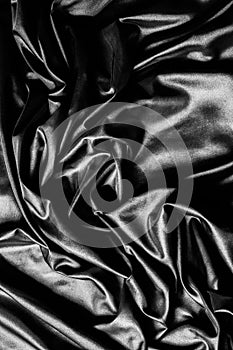 Texture, background, pattern. Black silk fabric. Fabric silk elastane satin black flowing stretch noble