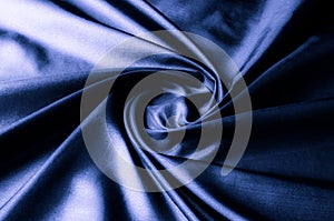 Texture, background, pattern. Dark blue silk fabric. Designer So