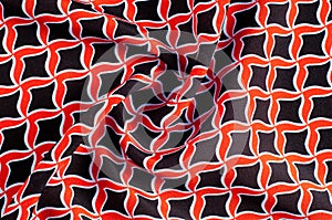 Texture, background, pattern. Fabric drawing of a diamond diamond red on a black background
