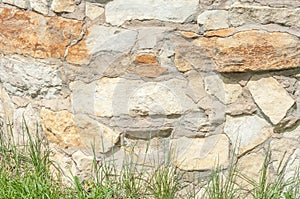 Texture, background, pattern. Granite stone. Texture of gray granite. Outside wall of uneven stones. White and pale red stones. T