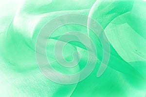 Texture, background, pattern. Green silk fabric for draping. Abs