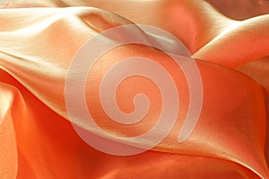 Texture, background, pattern. Orange Silk Fabric for Drapery Abs