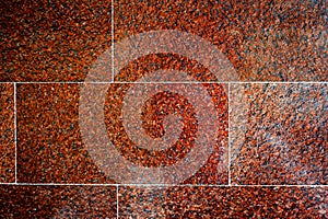 Texture, background, pattern. Photo of red granite. Facing granite slabs. Plane polished granite plate closeup as background.