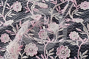 Texture, background, pattern. Pink lace decorated with flowers o