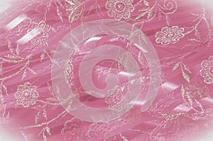 Texture, background, pattern. Pink lace decorated with flowers o