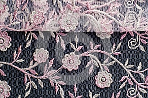 Texture, background, pattern. Pink lace decorated with flowers o