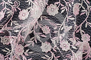 Texture, background, pattern. Pink lace decorated with flowers o