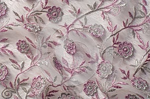 Texture, background, pattern. Pink lace decorated with flowers o