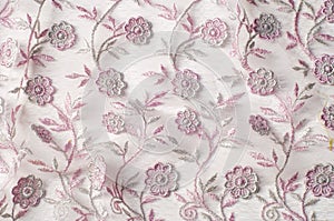 Texture, background, pattern. Pink lace decorated with flowers o