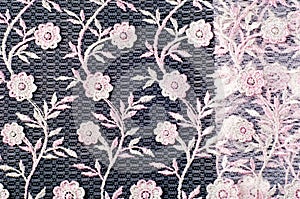 Texture, background, pattern. Pink lace decorated with flowers o