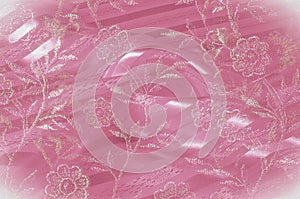 Texture, background, pattern. Pink lace decorated with flowers o