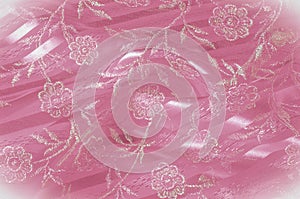 Texture, background, pattern. Pink lace decorated with flowers o