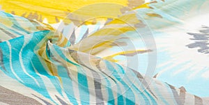 Texture background pattern. Silk fabric with colored lace. Yellow blue and gray-blue shades. It is perfect for your design,