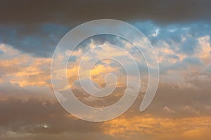 Texture, background, pattern. The sky is at sunset, dawn. Colored clouds, red, dark blue, orange, pastel colors. Romantic pastel