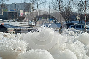 Texture, background, pattern. The spring snow melts. The beginning of a warm season, spring. Melting snow on the ground in the ci