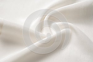 Texture background pattern. White silk fabric. Closeup of a rippled white silk fabric. Advertising space. Smooth elegant white si