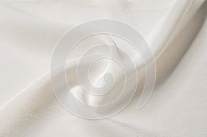 Texture background pattern. White silk fabric. Closeup of a rippled white silk fabric. Advertising space. Smooth elegant white si